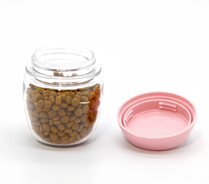 Clear jar with dog food and pink lid on a white background
