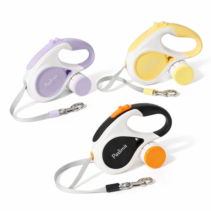 Three retractable dog leashes in different colors on a white background