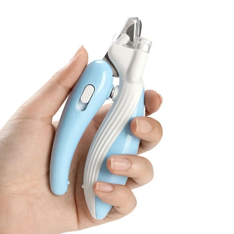 Hand holding a blue and white pet nail clipper against a white background
