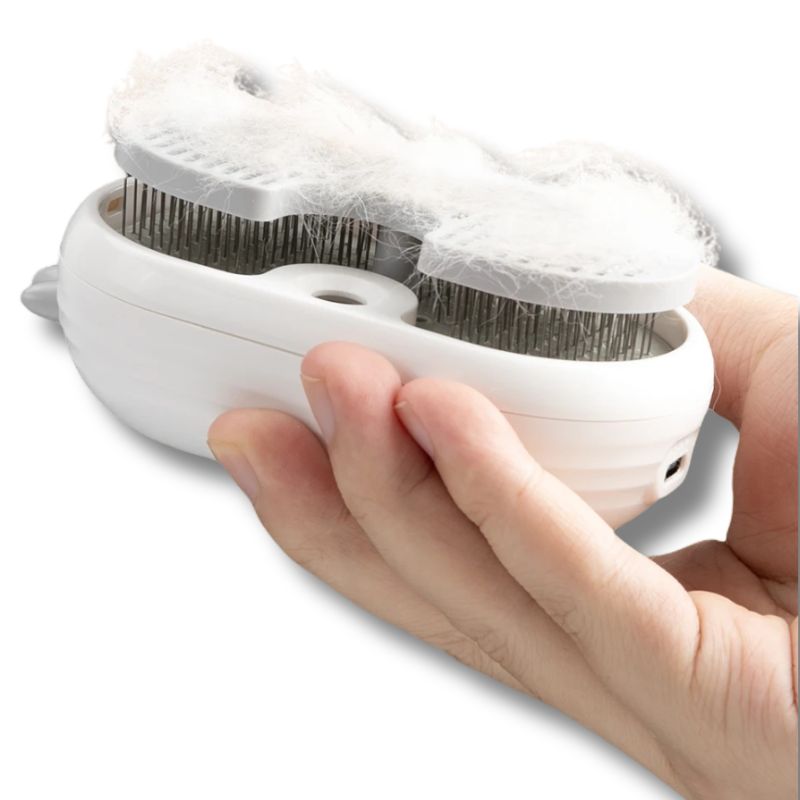 Dog grooming brush gently removing loose hair from pet coat indoors on a white background