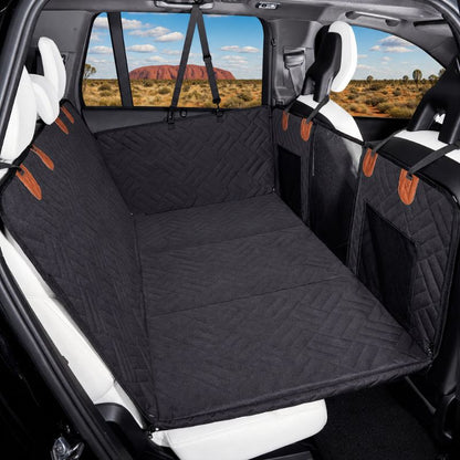 Car seat cover with a patterned design installed in a vehicle, showing a scenic view outside.