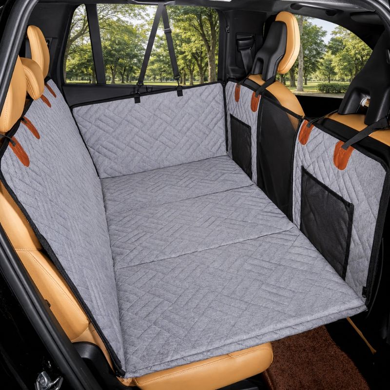 Car interior with a gray quilted bench seat cover and brown leather seats.