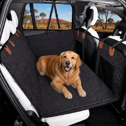 Dog sitting on a black car seat cover with a scenic background